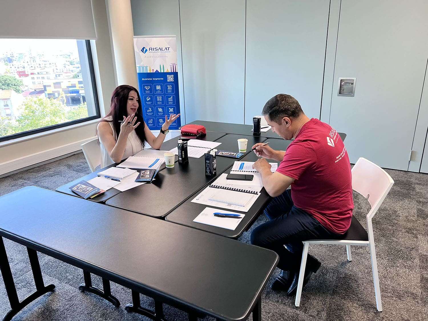 Project Design, Proposal Writing and Fundraising Training session in progress with two people at a table.