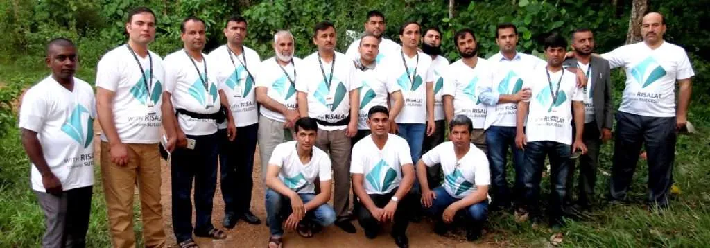 Risalat Consultants International team stands outdoors.