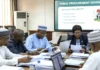 Government procurement reform meeting reviewing public procurement contracts and bid evaluation